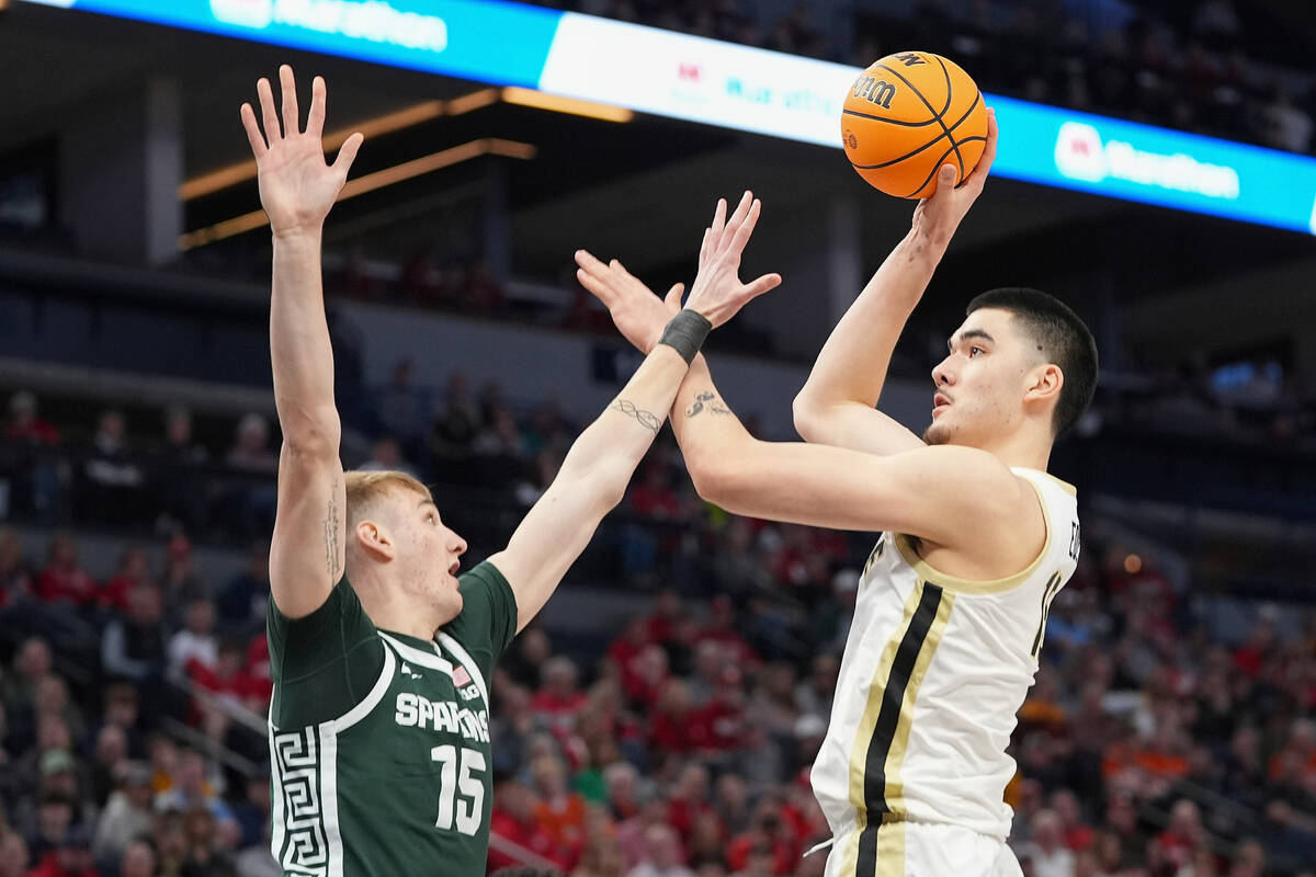 Purdue center Zach Edey, right, shoots over Michigan State center Carson Cooper (15) during the ...