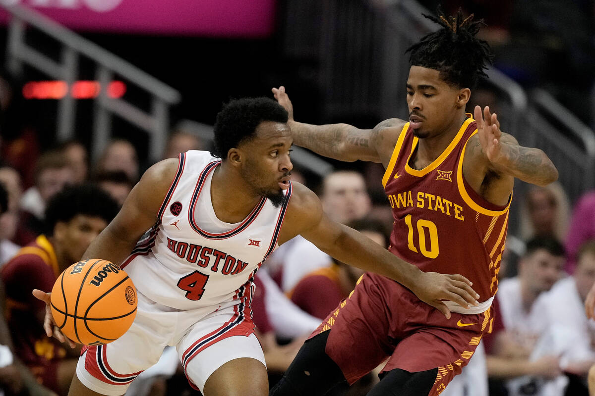 Houston guard L.J. Cryer (4) drives past Iowa State guard Keshon Gilbert (10) during the first ...