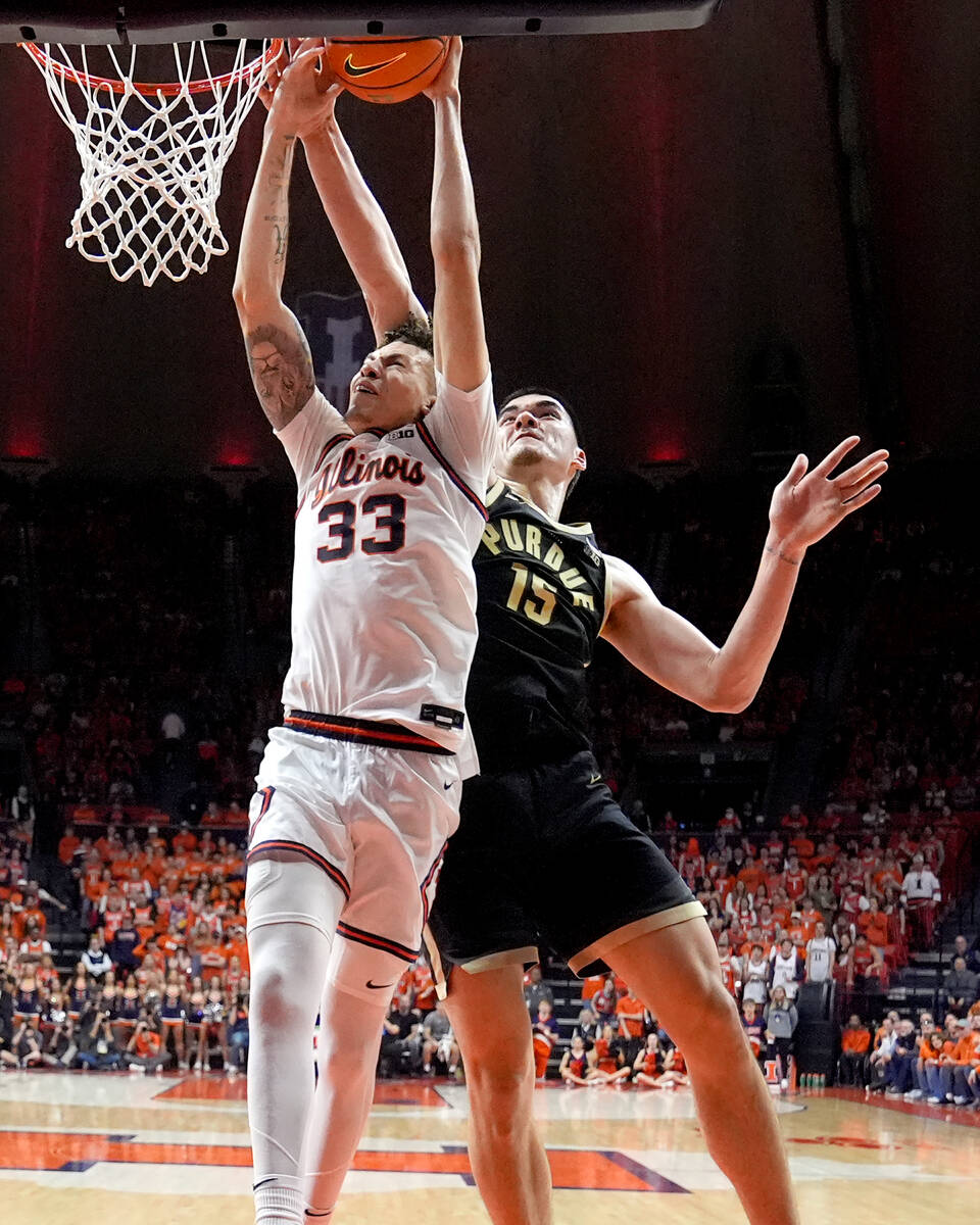 Purdue's Zach Edey (15) blocks a dunk attempt by Illinois' Coleman Hawkins during the second ha ...