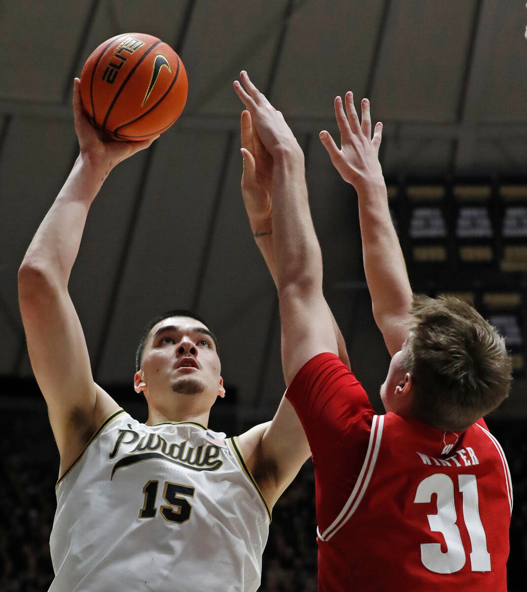 Purdue center Zach Edey (15) shoots the ball over Wisconsin forward Nolan Winter (31) during th ...