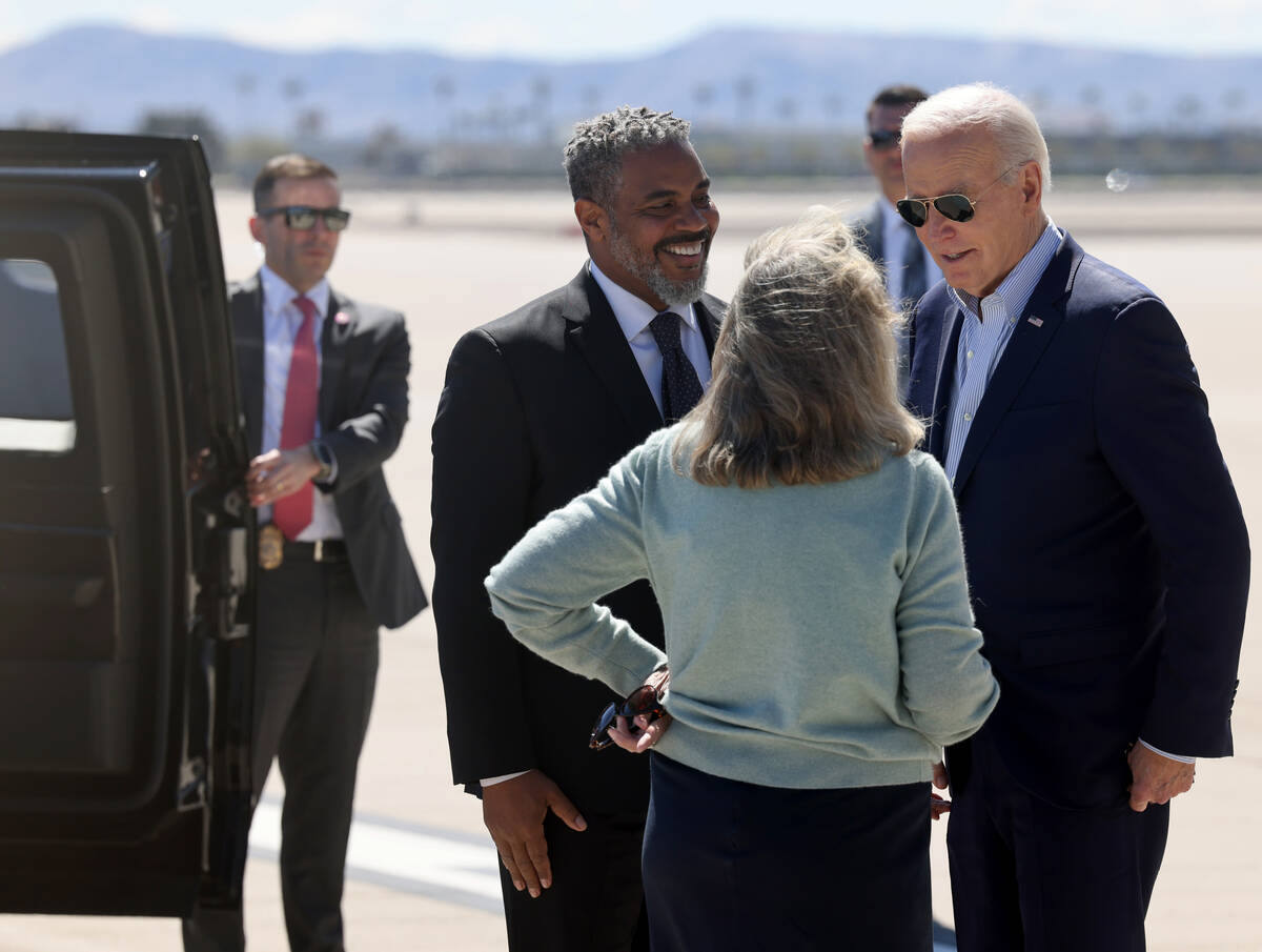 President Joe Biden greets U.S. Reps. Steven Horsford and Dina Titus after arriving on Air Forc ...