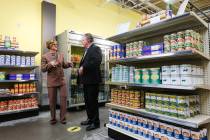 Rep. Susie Lee, D-Nev., left, and CEO Tom Roberts, right, take a tour of the food pantry at Cat ...