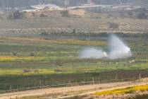 An Israeli tank, center, moves near the Israeli-Gaza border as seen from southern Israel, Monda ...