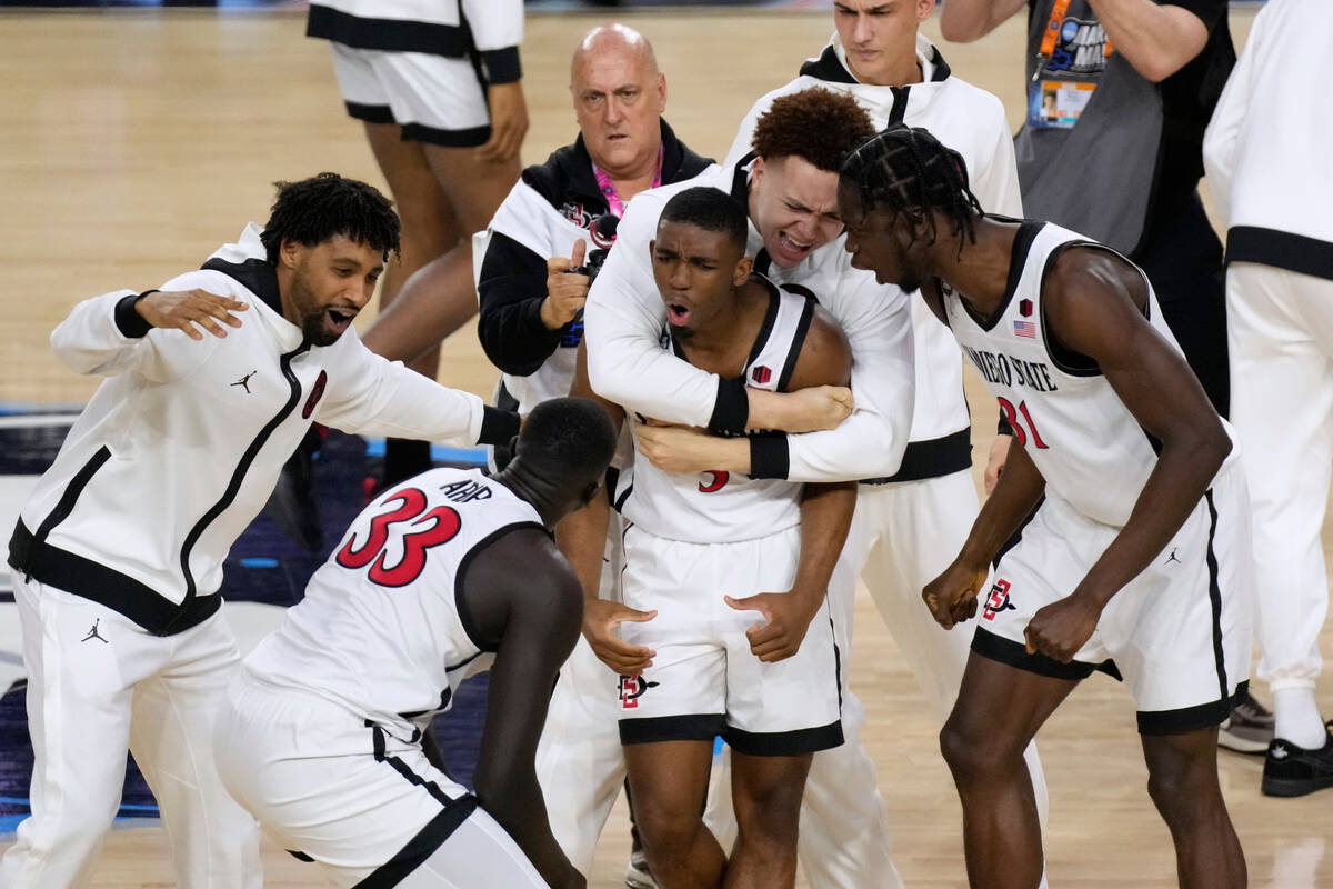 San Diego State guard Lamont Butler, center, celebrates with teammates after he hit the winning ...