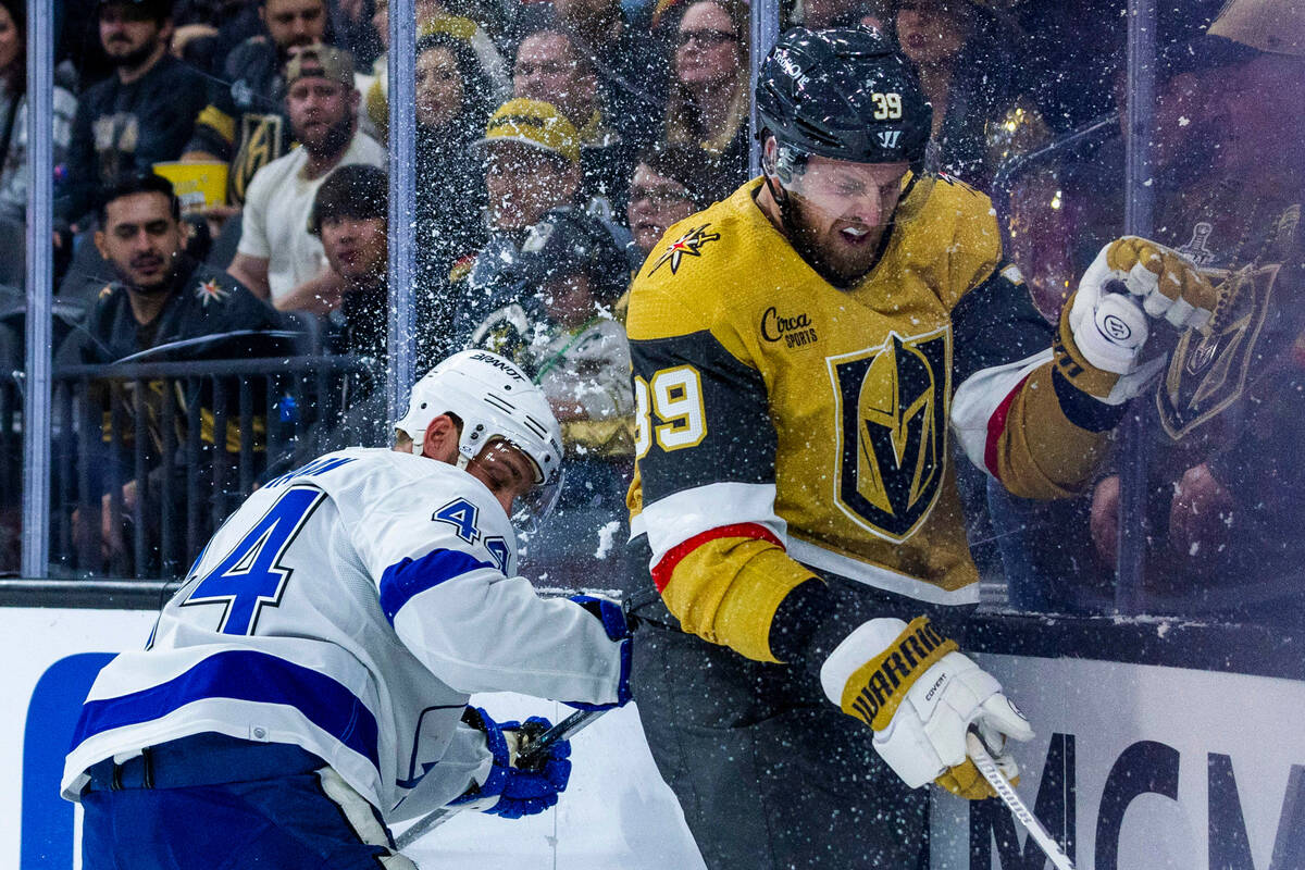 Golden Knights right wing Anthony Mantha (39) is checked into the glass by Tampa Bay Lightning ...