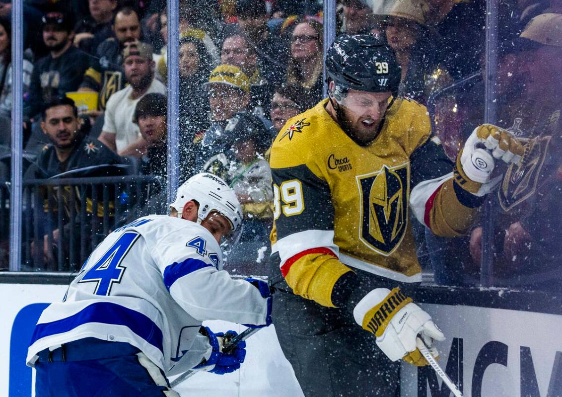 Golden Knights right wing Anthony Mantha (39) is checked into the glass by Tampa Bay Lightning ...