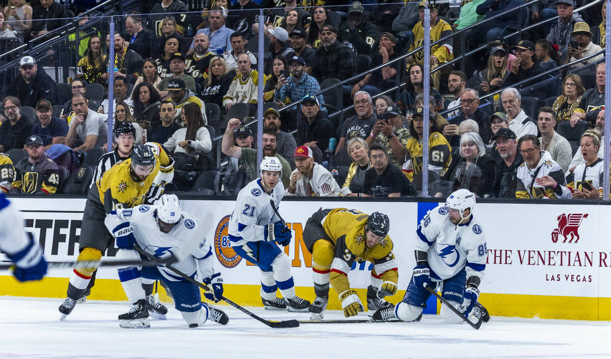 Golden Knights and Tampa Bay Lightning players battle on the ice during the first period of the ...