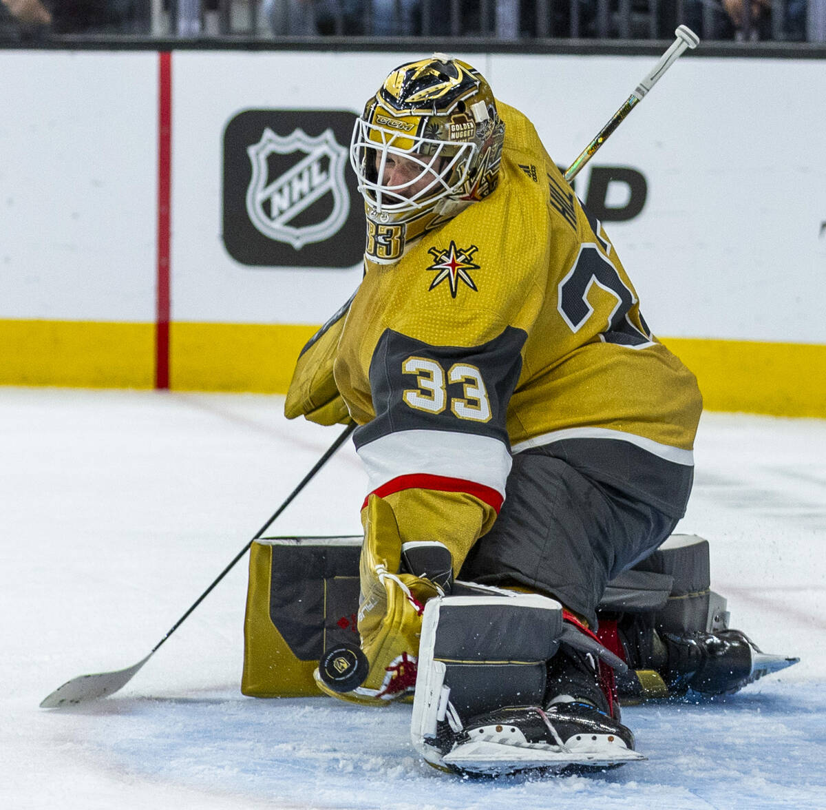 Golden Knights goaltender Adin Hill (33) readies to snag a puck shot by the Tampa Bay Lightning ...