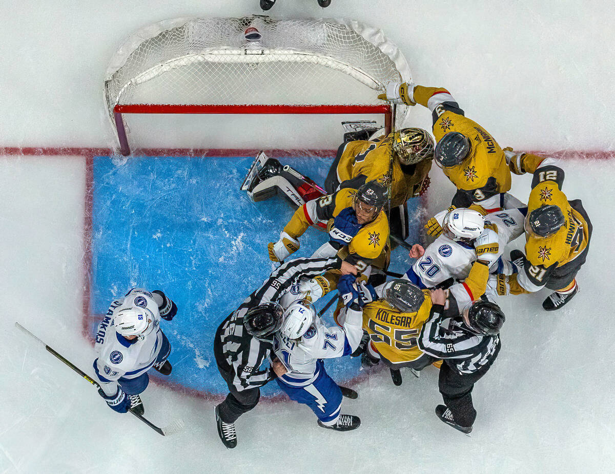 Golden Knights and Tampa Bay Lightning players fight after Golden Knights goaltender Adin Hill ...