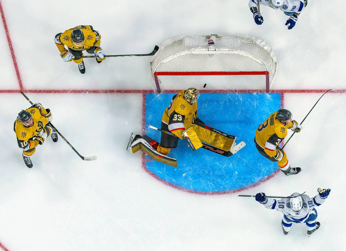 Golden Knights goaltender Adin Hill (33) is unable to stop a score by Tampa Bay Lightning left ...