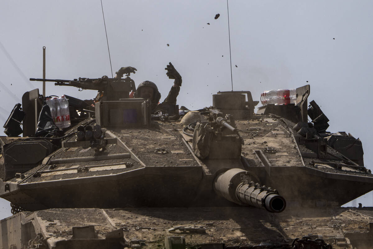 Israeli soldiers drive a tank on the border with Gaza Strip, in southern Israel, Tuesday, March ...