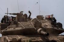 Israeli soldiers drive a tank on the border with Gaza Strip, in southern Israel, Tuesday, March ...