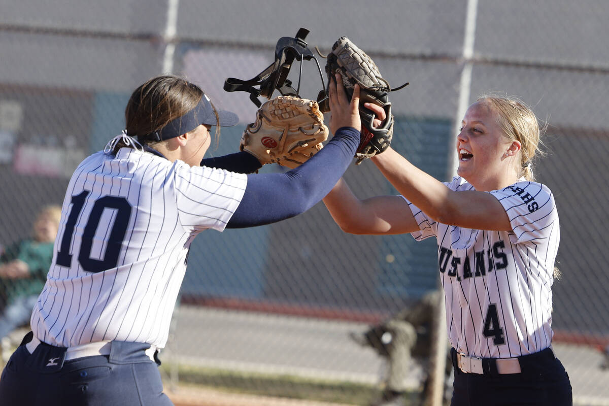 Shadow Ridge pitcher Josslin Law (4) gets a high-five from her teammate Abby Covington (10) aft ...