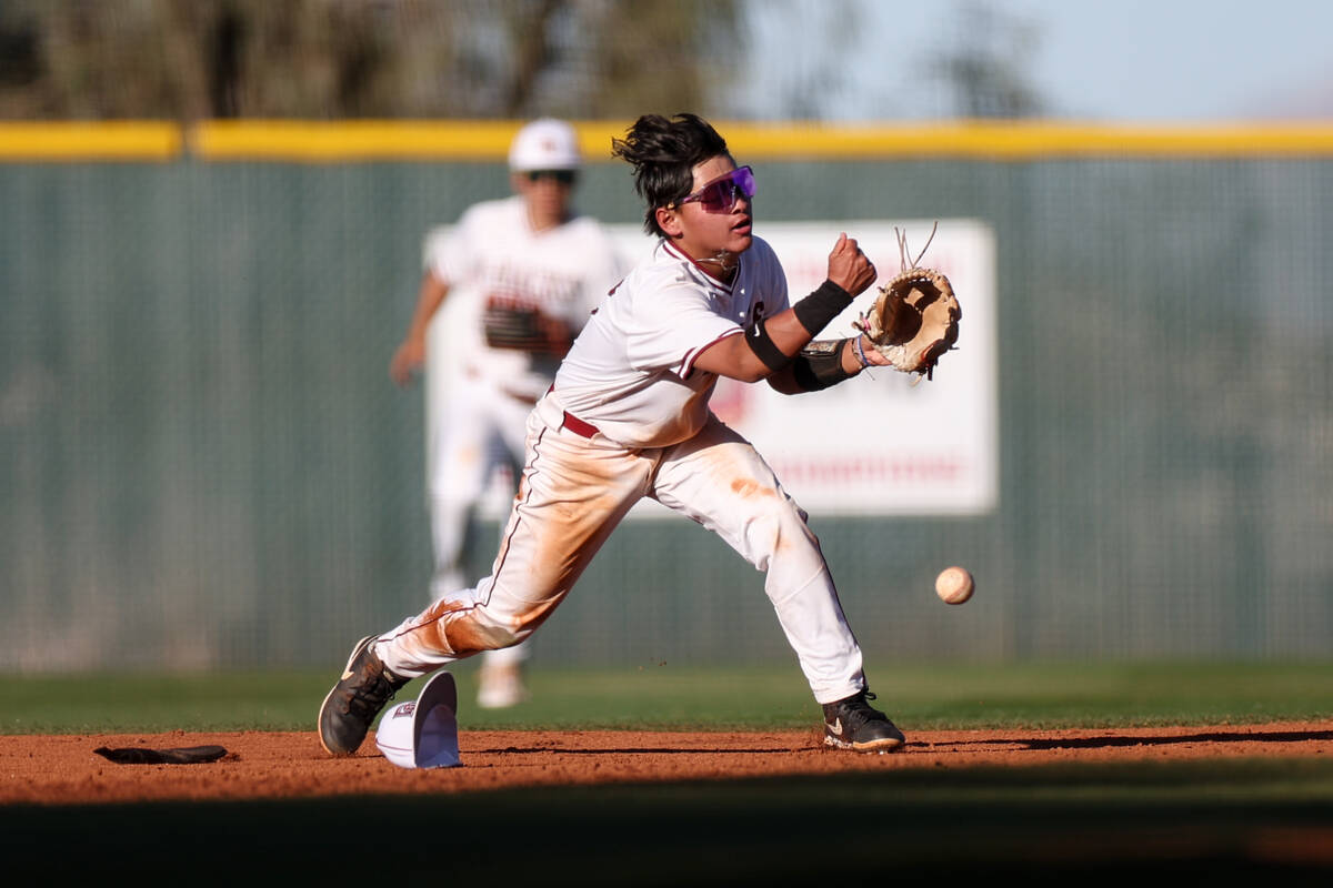 Desert Oasis shortstop Lincoln Guillermo throws to second base for an out on Las Vegas during a ...