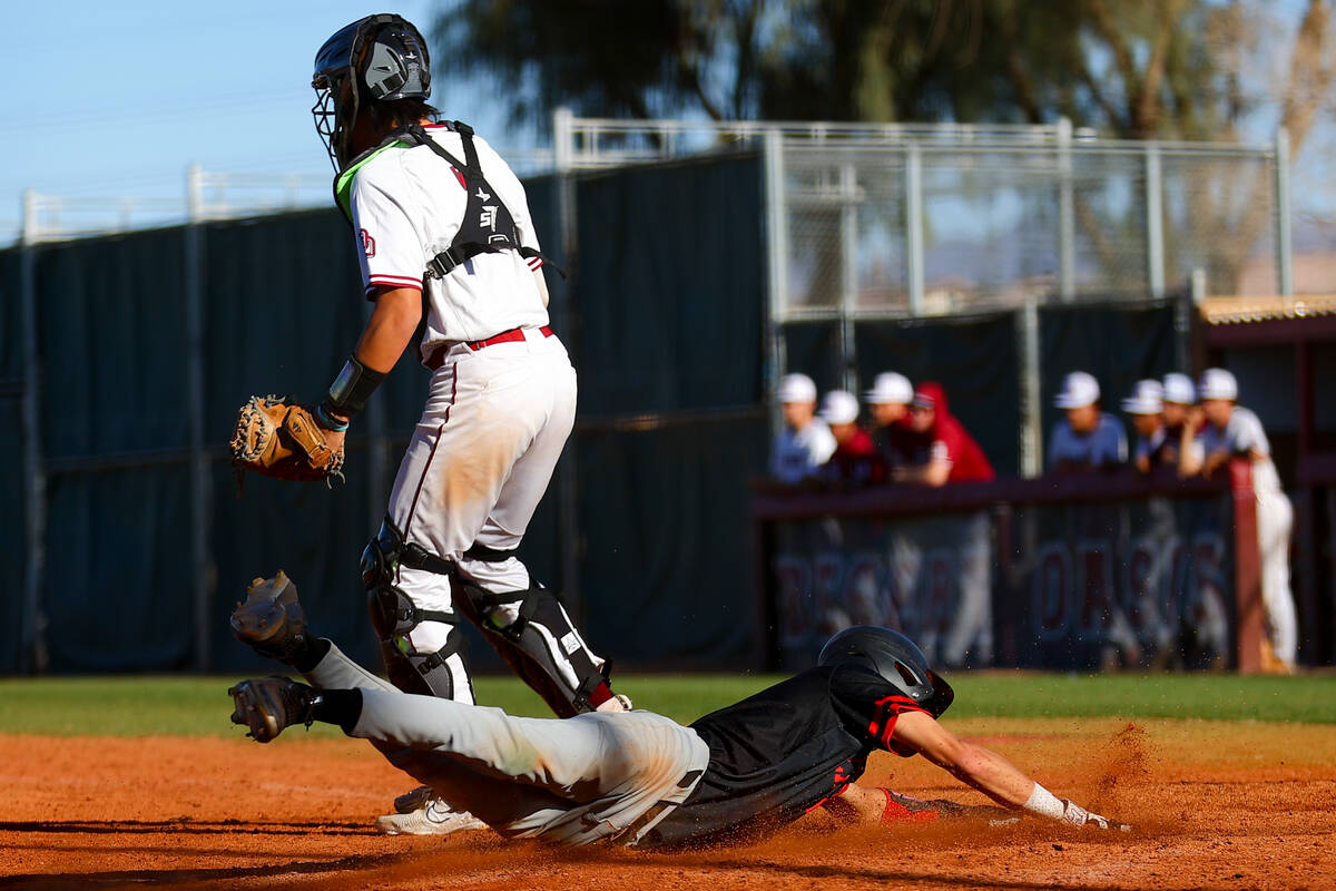 Las Vegas’ Mickey Martinez slides into home plate while Desert Oasis’ Isaiah Sori ...