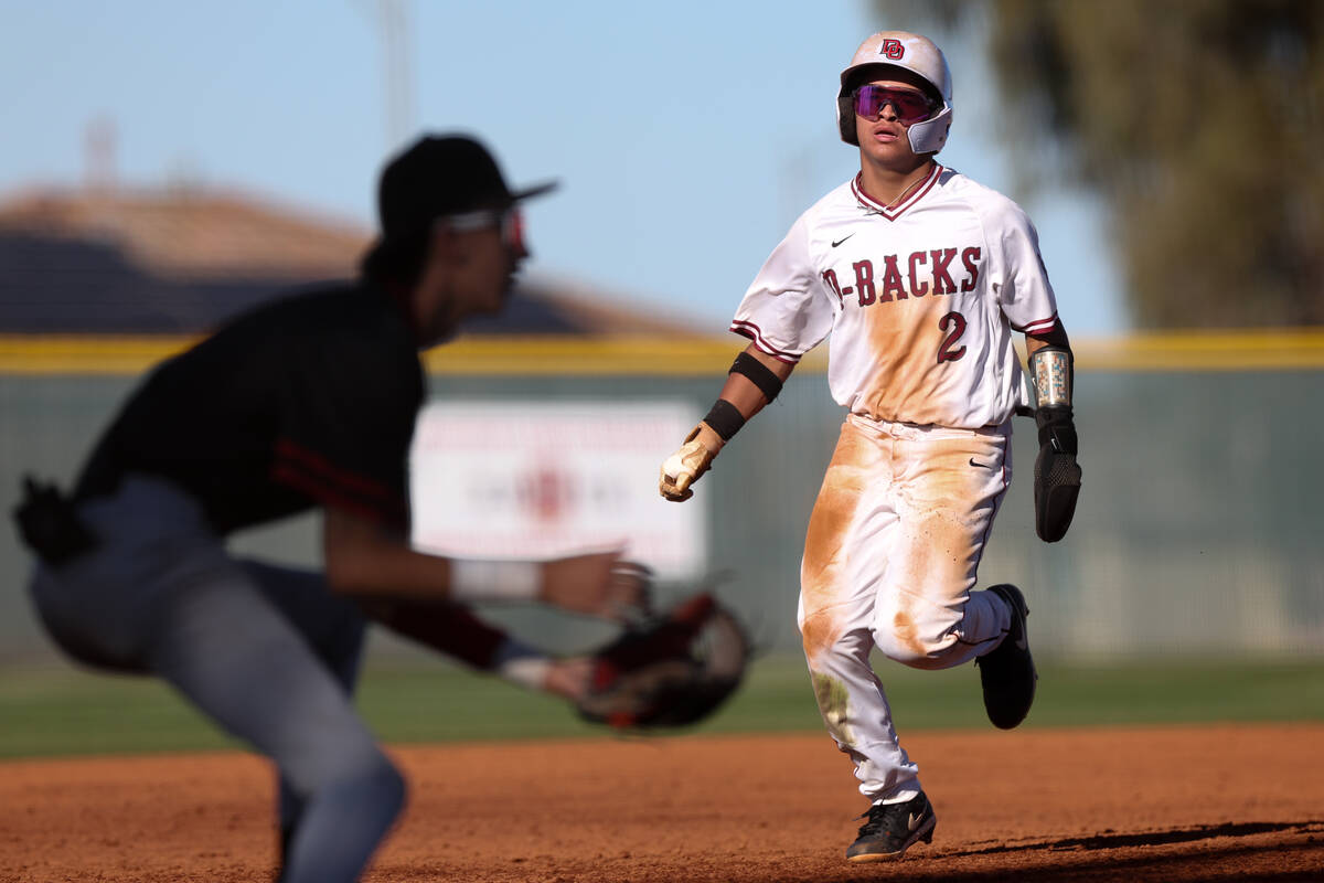 Desert Oasis shortstop Lincoln Guillermo (2) runs to third base during a high school baseball g ...