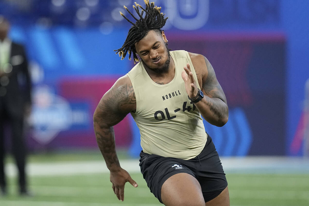 Alabama offensive lineman JC Latham runs a drill at the NFL football scouting combine, Sunday, ...