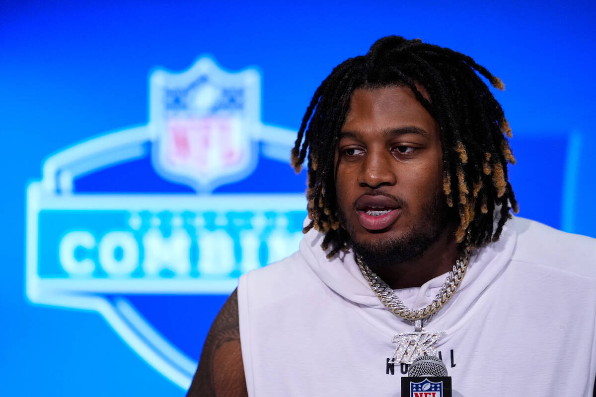 Alabama offensive lineman JC Latham speaks during a press conference at the NFL football scouti ...