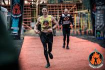Boulder City’s Tyler Nash crosses the finish line following one of his eight Toughest Mudder ...