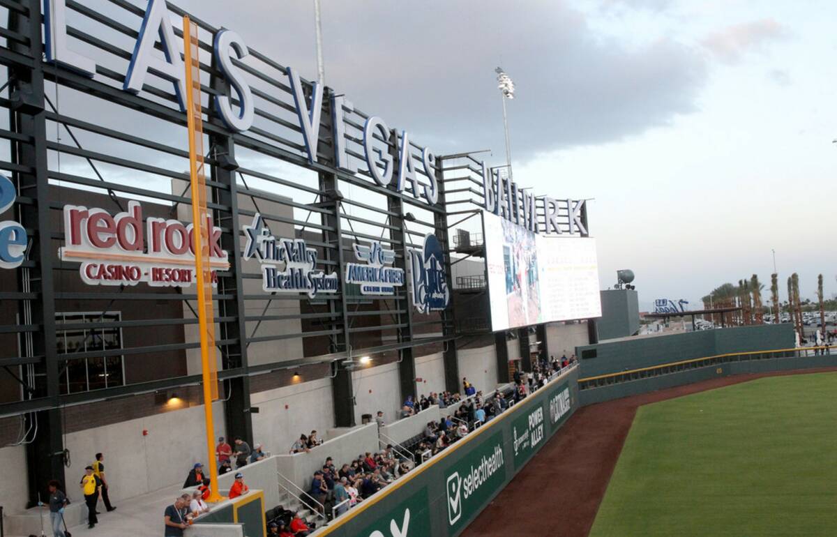 Fans watch the action from the left field wall during opening night for the Las Vegas Aviators ...