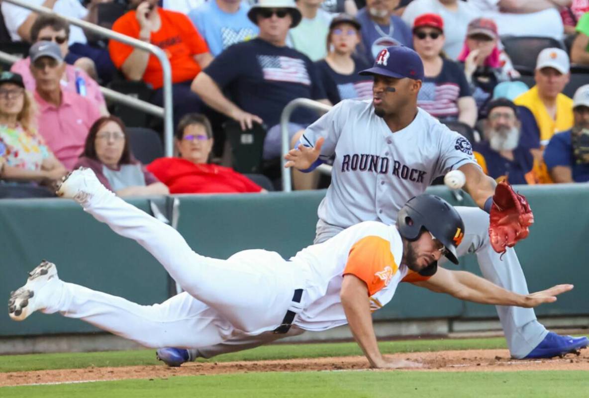 Aviators' Drew Jackson (6) leaps back to third base against Round Rock Express’ Andy Ibanez ( ...