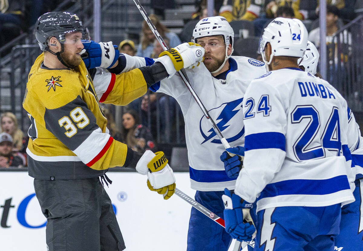 Golden Knights right wing Anthony Mantha (39) trades punches with Tampa Bay Lightning defensema ...