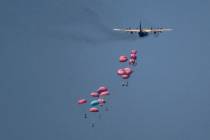 An aircraft airdrops humanitarian aid over northern Gaza Strip, as seen from southern Israel, W ...