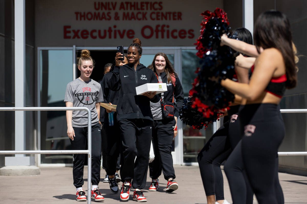 UNLV Lady Rebel center Desi-Rae Young, center, and her teammates walk out of the Thomas &a ...