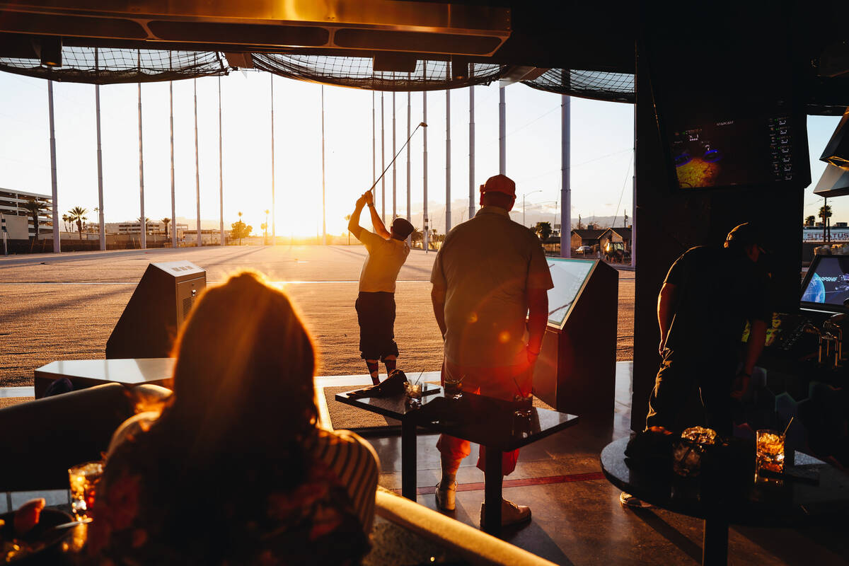 Golfers try out the bays at Atomic Golf on Wednesday, March 20, 2024, in Las Vegas. (Madeline C ...