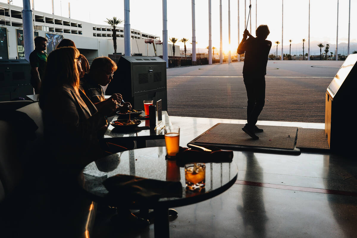 Golfers try out the bays at Atomic Golf on Wednesday, March 20, 2024, in Las Vegas. (Madeline C ...