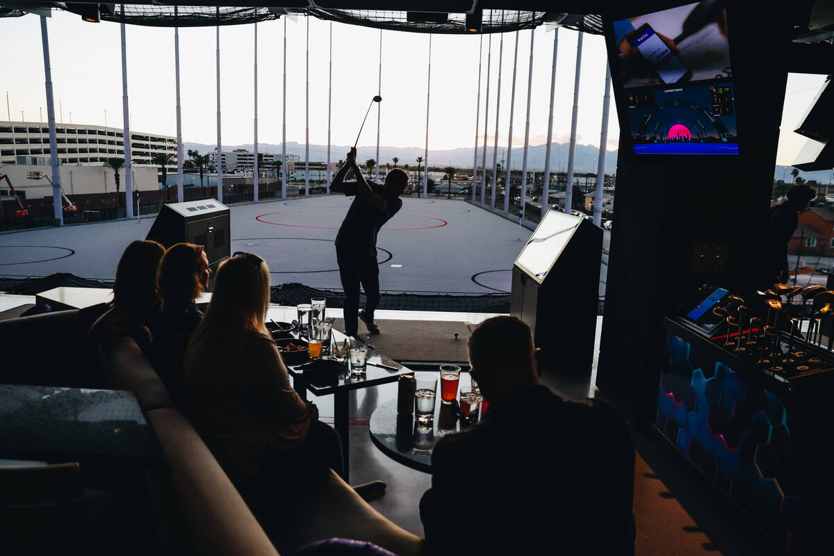 Golfers try out the bays at Atomic Golf on Wednesday, March 20, 2024, in Las Vegas. (Madeline C ...