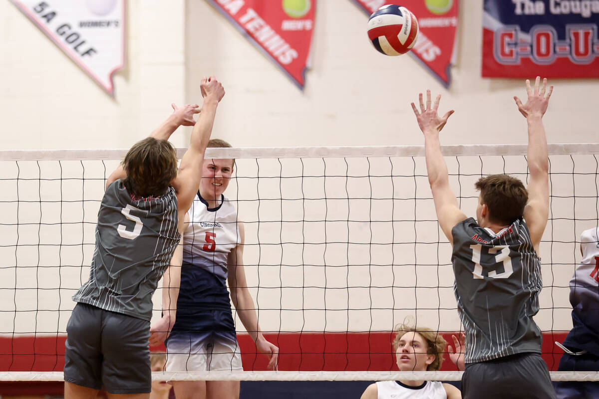 Coronado outside hitter Dexter Brimhall (5) spikes past Arbor View outside hitter Mark Blanchar ...