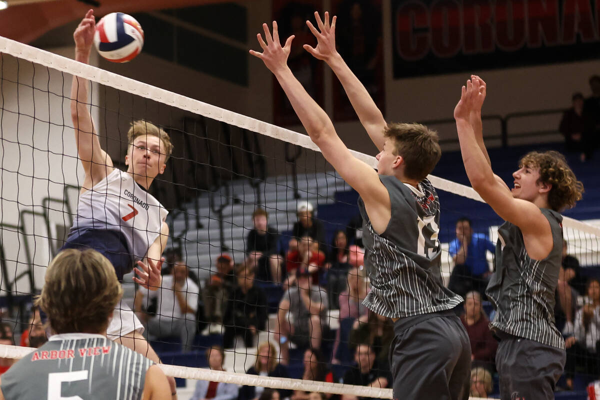 Coronado outside hitter Dane Galvin (7) spikes while Arbor View middle blocker Owen Wenger (13) ...