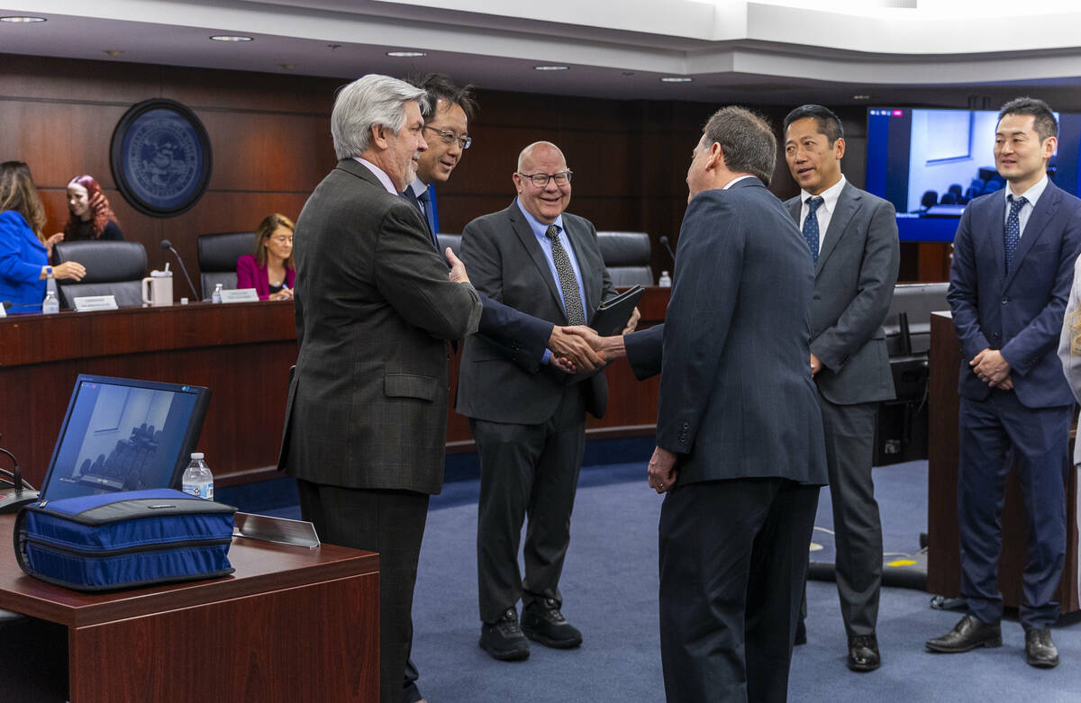 Commissioner Brian Krolicki, back, greets attendees to the Nevada Gaming Commission meeting on ...