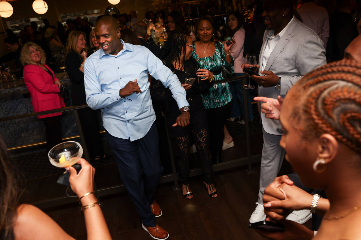 Guests dance to a live saxophonist during an opening night party at Emmitt's Vegas in Fashion S ...