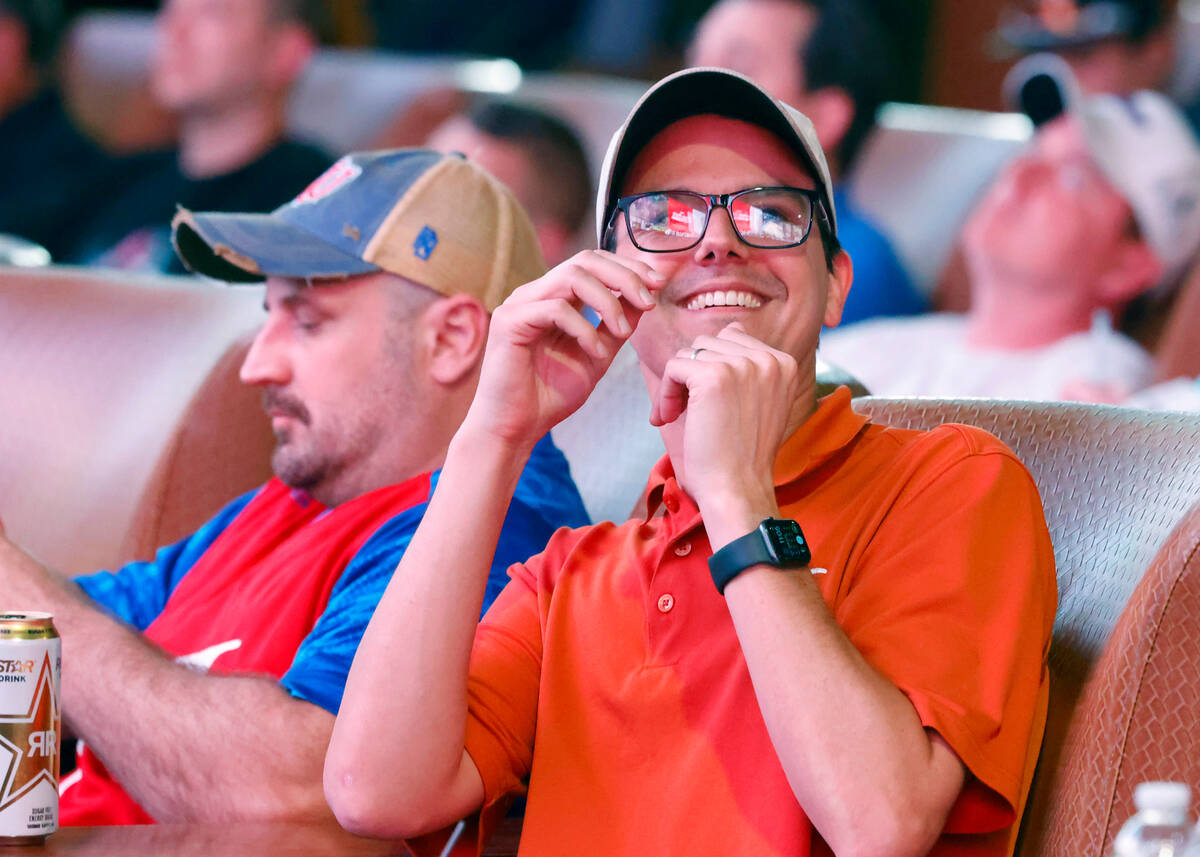 Gus Hodcrofter of Texas reacts to a play as he watches on the big screens the first day of the ...