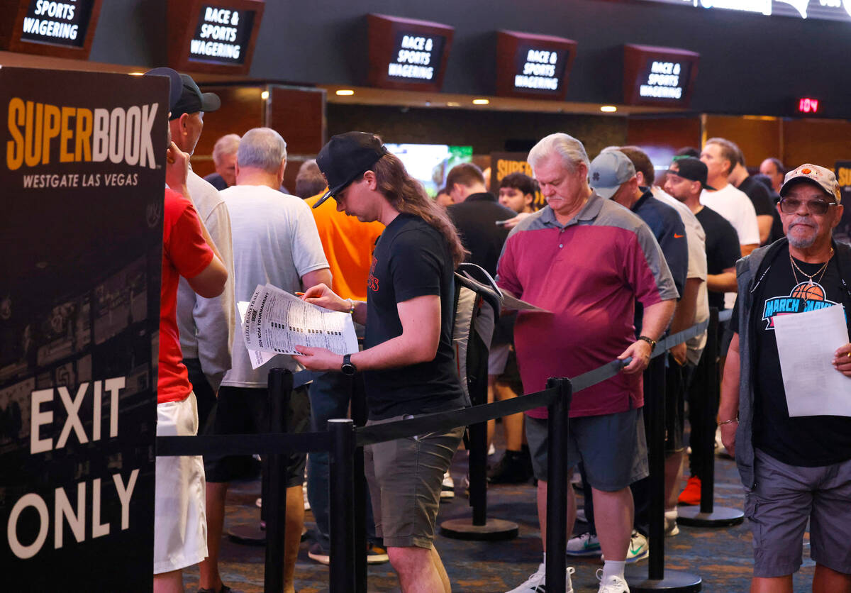 People wait in line to bet on the NCAA basketball tournament at Westgate sports book, on Thursd ...