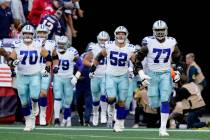 Dallas Cowboys run onto the field before the first half of an NFL football game, Sunday, Oct. 1 ...
