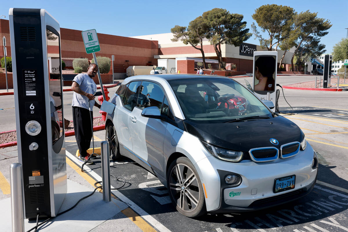 James Jackson charges his electric vehicle at Meadows mall in Las Vegas on Thursday, March 21, ...