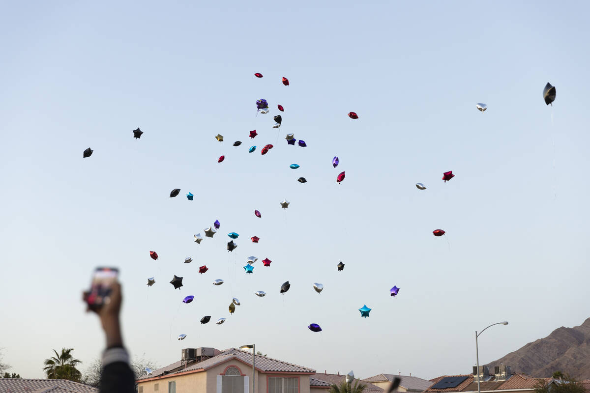 Balloons are released during a vigil in memory of Devin Heath, who died after being hit by a sp ...