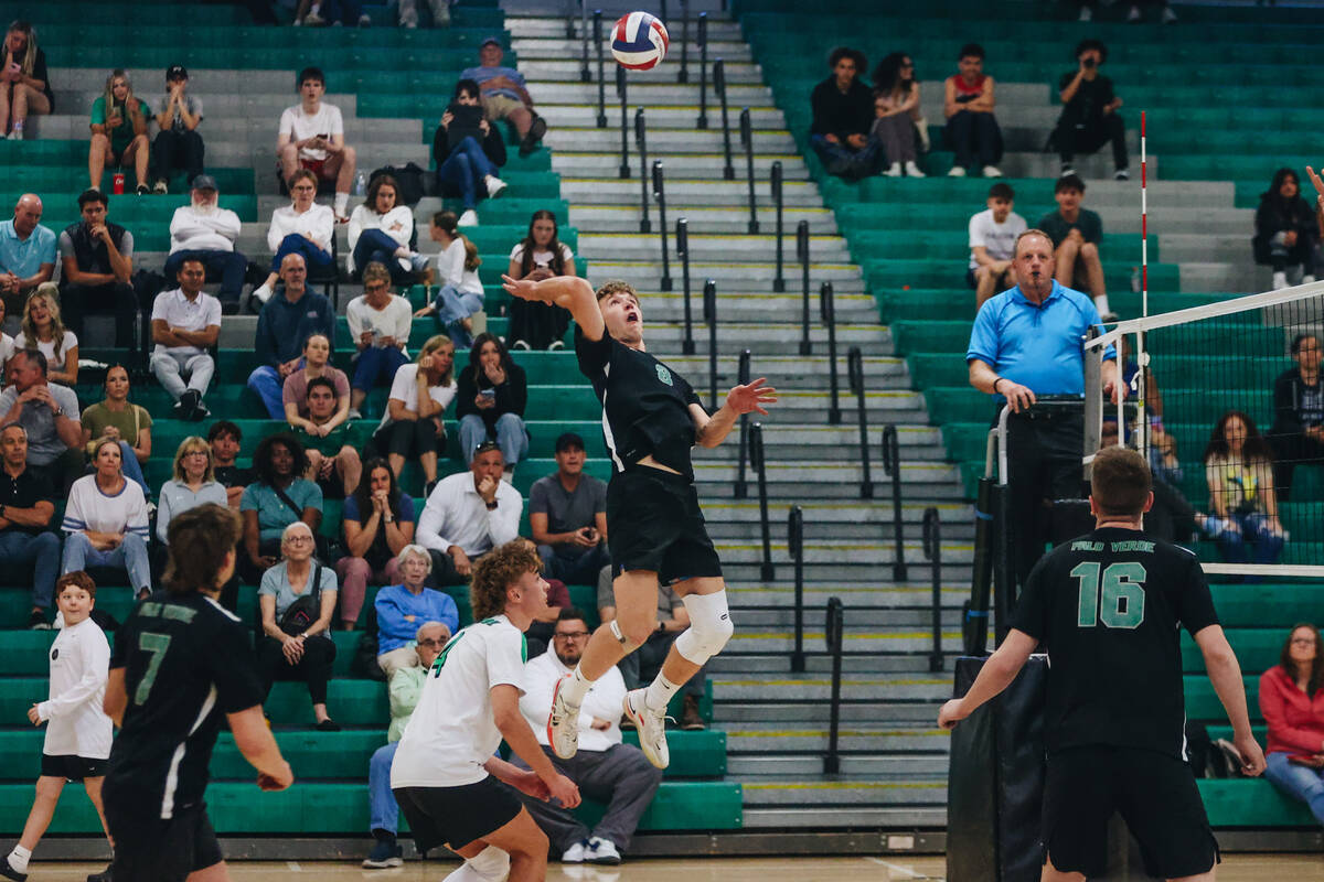 Palo Verde outside hitter Cole Manning (8) jumps up to hit the ball over the net during a game ...