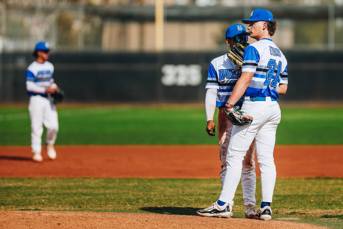 Basic pitcher Lincoln Evans (21) speaks to a teammate while on the pitching mound during a base ...