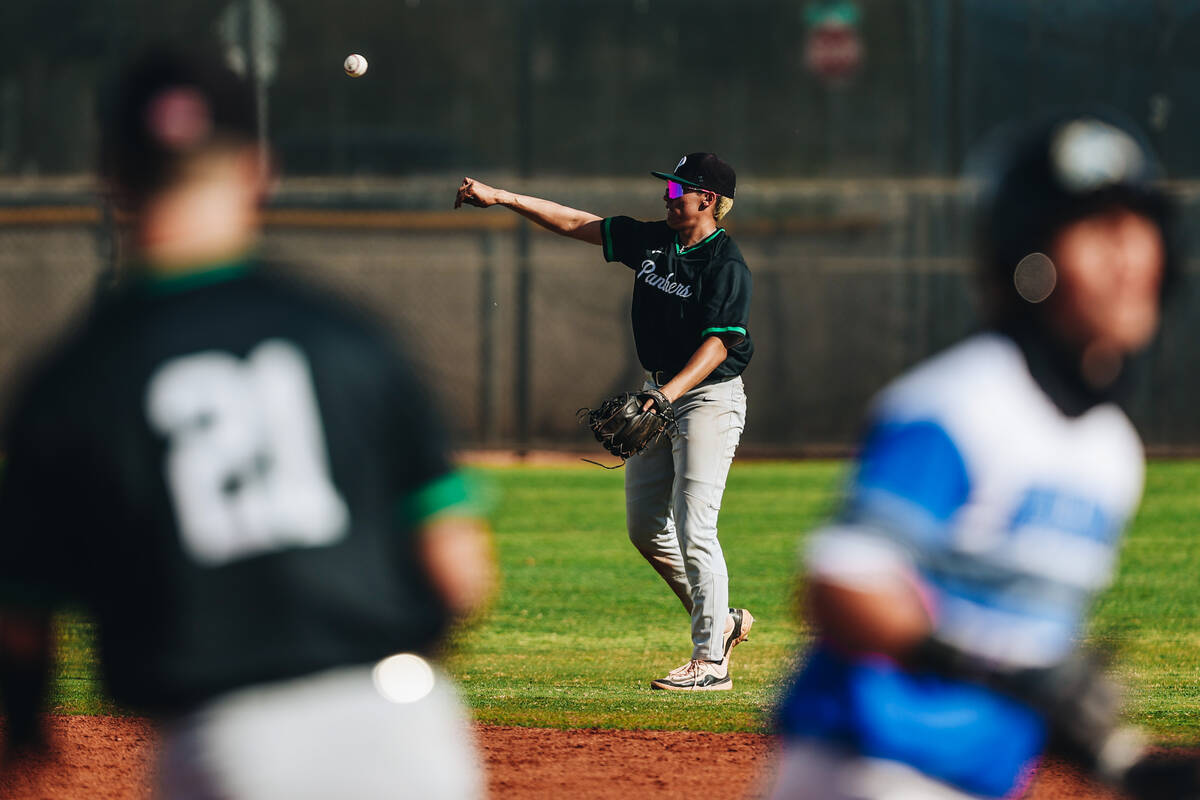 A Palo Verde baseball player throws the ball to a teammate for an assist during a baseball game ...