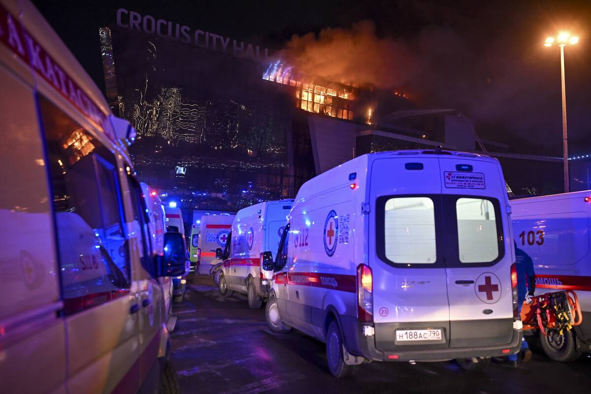 Ambulances park near a burning building of the Crocus City Hall on the western edge of Moscow, ...