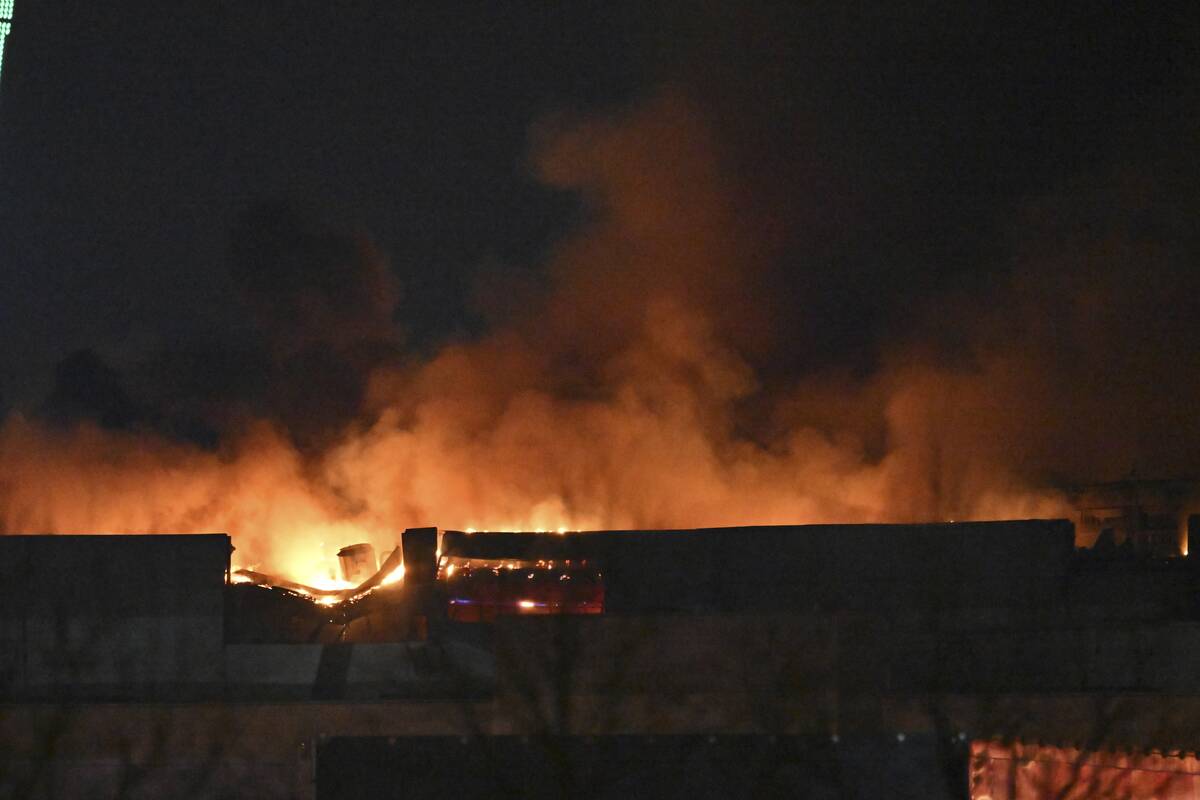 A massive blaze is seen over the Crocus City Hall on the western edge of Moscow, Russia, Friday ...