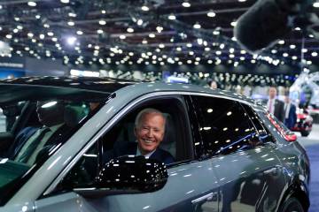 FILE - President Joe Biden drives a Cadillac Lyriq through the showroom during a tour at the De ...
