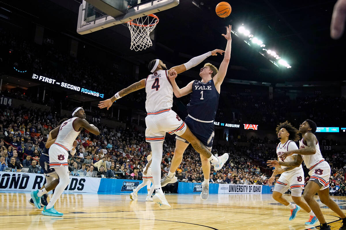 Yale forward Danny Wolf (1) shoots over Auburn forward Johni Broome (4) during the second half ...