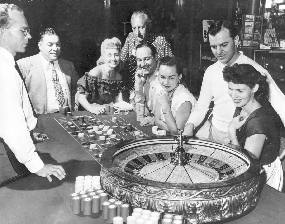FILE - People are shown at one of the gaming tables at the Flamingo Casino in Las Vegas, Nev., ...