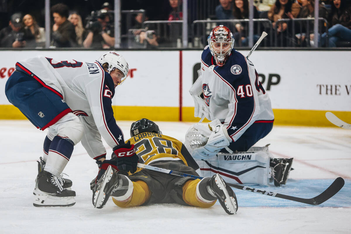 Golden Knights left wing William Carrier (28) fans onto the ice as Columbus Blue Jackets goalte ...