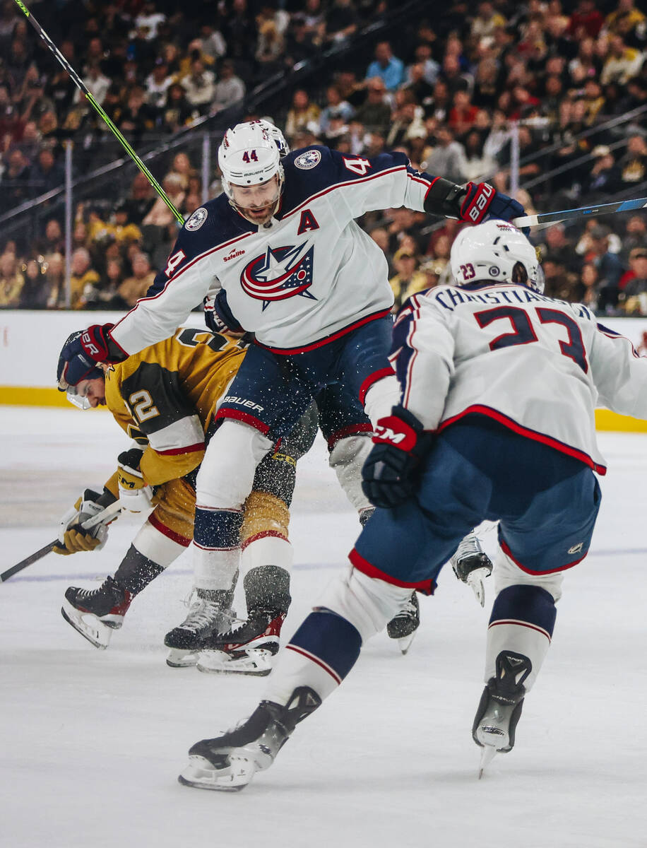 Golden Knights right wing Michael Amadio (22) fights to stay standing as Columbus Blue Jackets ...